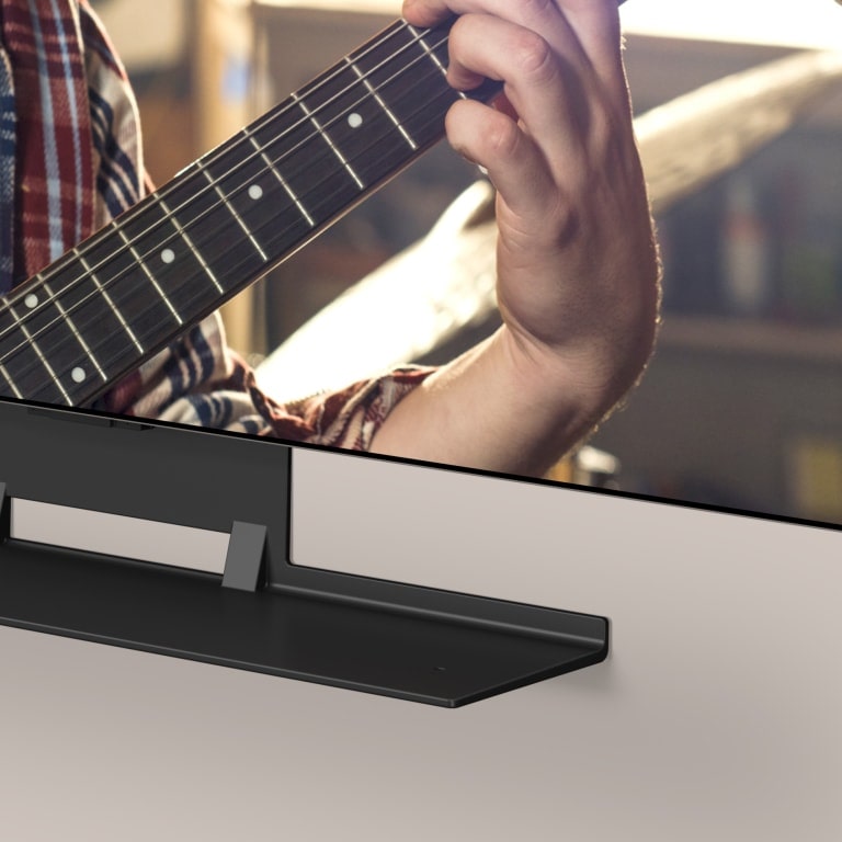 LG OLED TV and Synergy bracket are shown within an angled view of the bottom. The LG Soundbar slots into the Synergy Bracket.
