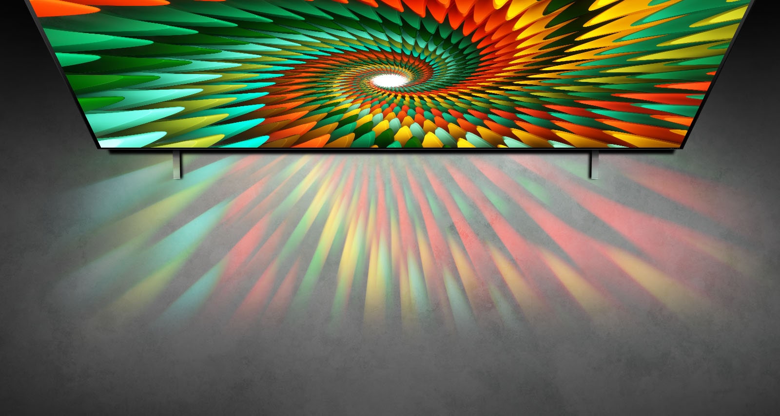 Un televisor en una habitación completamente blanca muestra una forma espiral de colores en la pantalla.