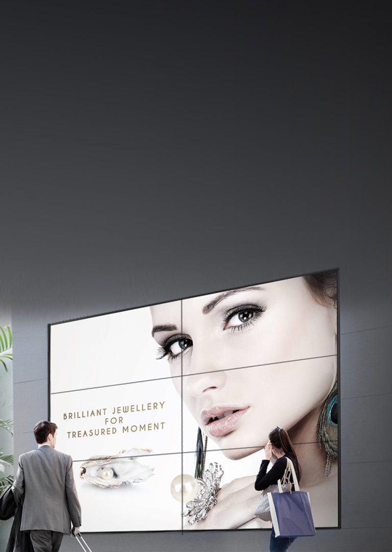 Business Man and Woman Walking by LG Video Wall