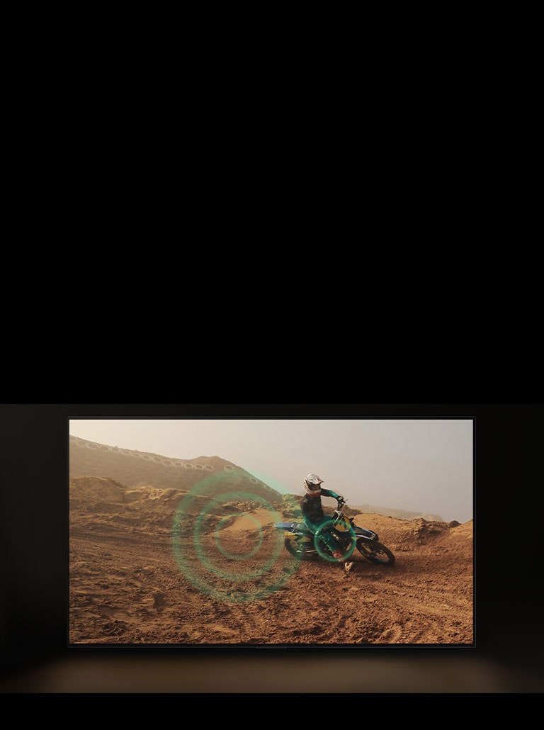 Un video de una persona practicando motocross sobre tierra roja y polvorienta. Al tomar una curva, aparecen burbujas sonoras de color verde en el volante. 