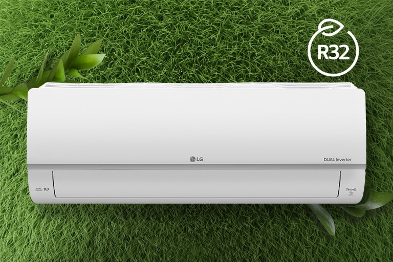 The LG Air conditioner is installed on a wall of grass. The R32 logo for energy efficiency is in the upper right corner.