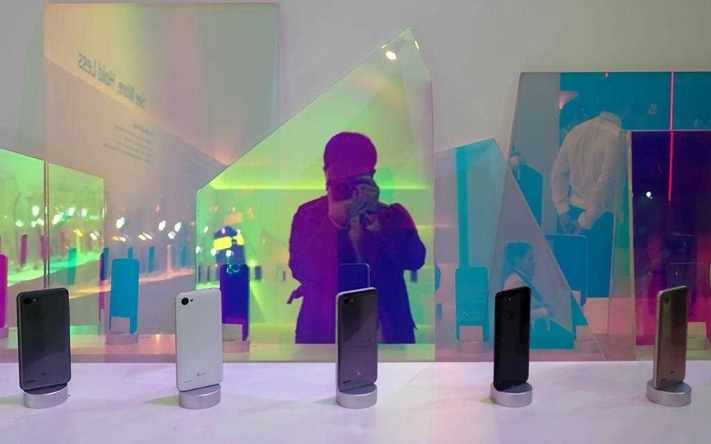 A photo of a man taking a photo of new lg q6 smartphone line up announced at mwc 2018 barcelona.