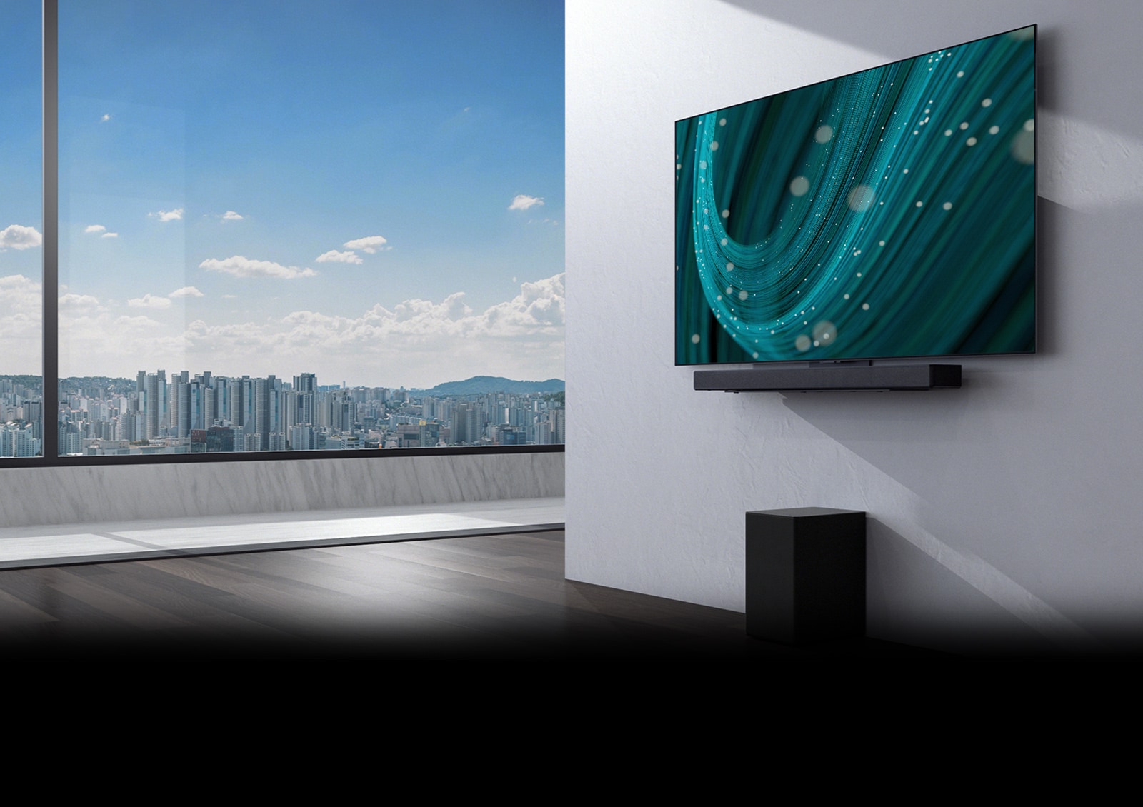 In the center of a space with a large window, there is a wall with a TV and soundbar mounted on it, and a subwoofer underneath. The screen displays a teal-colored background image.