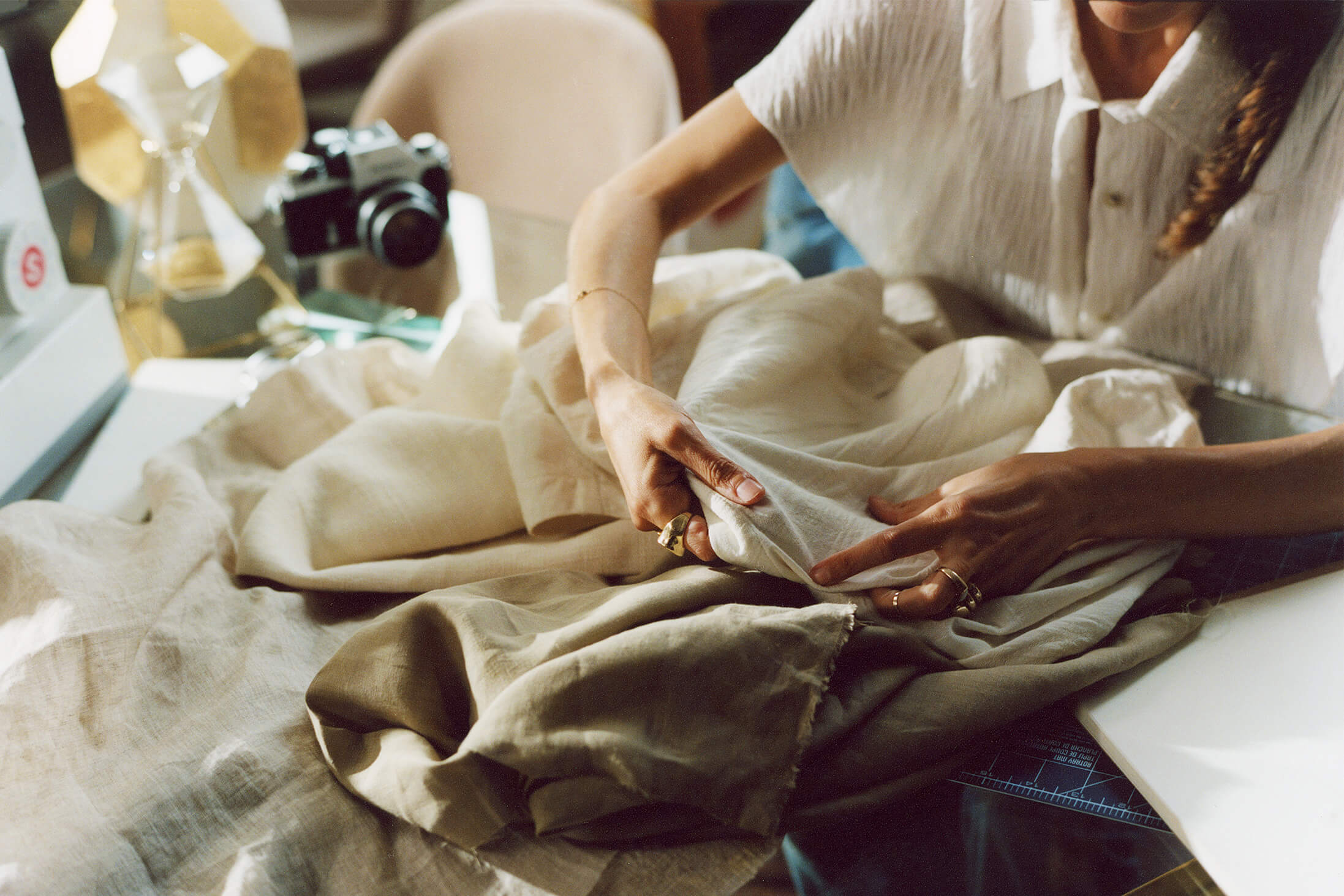 Image of Mara Hoffman designer modifying one of the pieces in the Winter Sun capsule collection.
