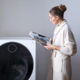 Thumbnail of Olivia Palermo stood next to an LG SIGNATURE Washing Machine.