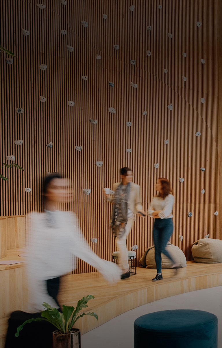 people walking through a office lobby