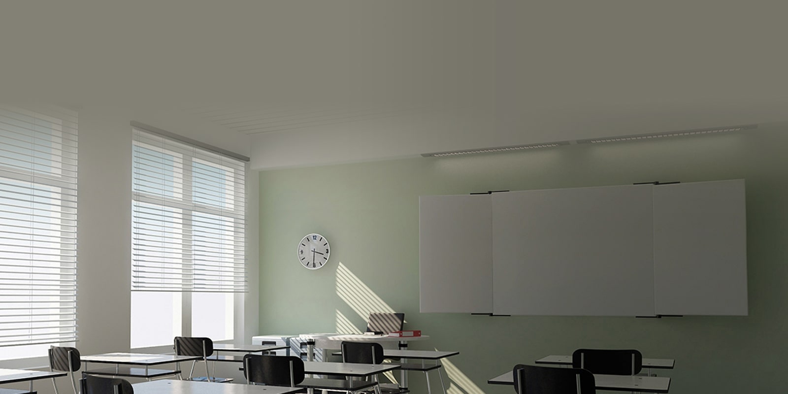 Một lớp học với ánh nắng chiếu qua cửa sổ, chiếc đồng hồ trên tường và vài bộ bàn ghế trước bảng đen.