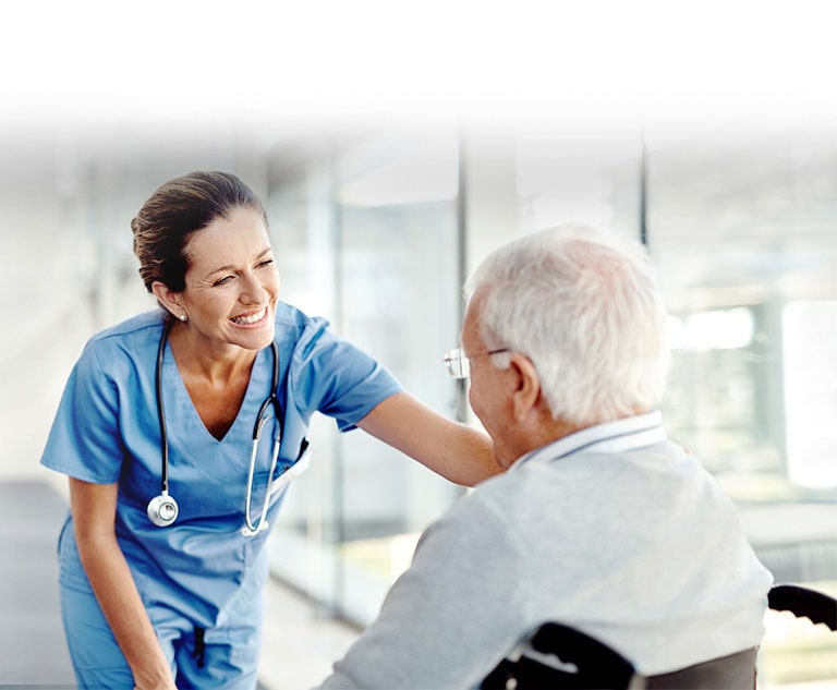 An image of a nurse smiling to a patient.