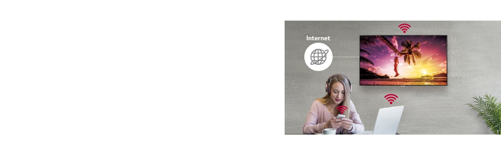 The UM3DG-H series is on the wall and a woman using a personal PC and mobile phone. And this image shows that the signage can be connected wirelessly to the PC and mobile phone she is holding.