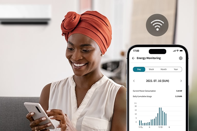Woman using the LG ThinQ app with kW Manager to monitor energy usage and view consumption graphs on her phone.