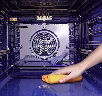 The image of wiping the inside of the oven with a cloth.