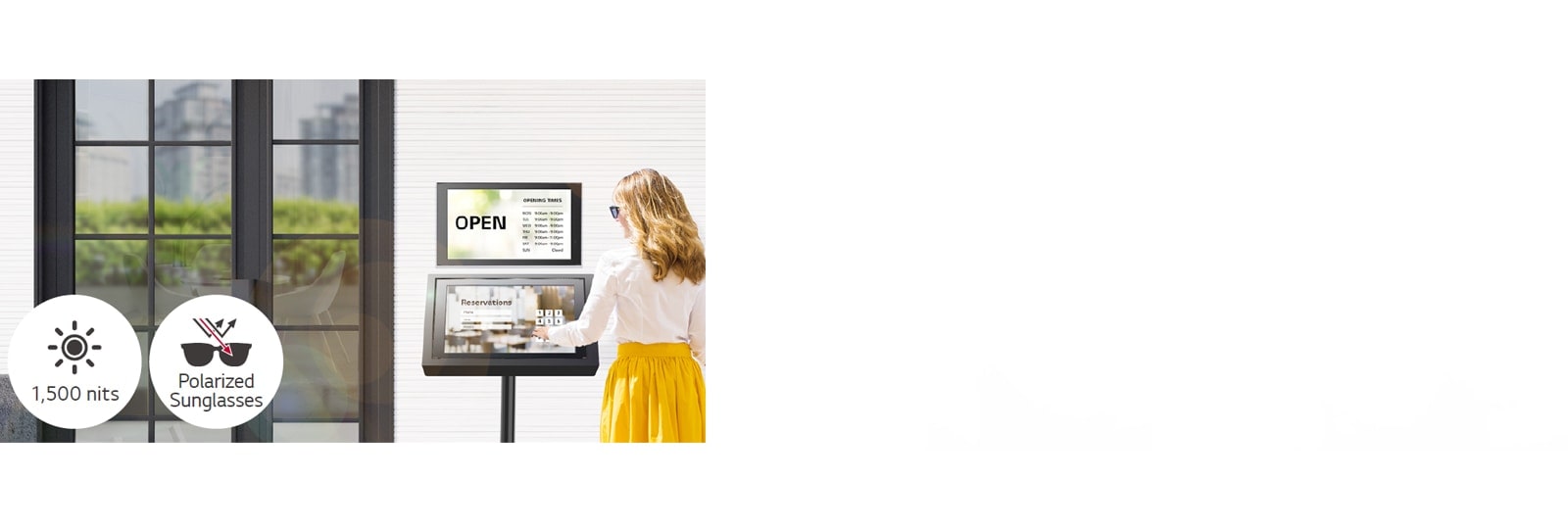 A 22XE1J is installed on the wall at the entrance of the building with another 22XE1J stand below for reservation purposes. The lady with sunglasses is using the 22XE1J screen with a touch overlay to make a reservation. The screen remains visible even when under direct sunlight.
