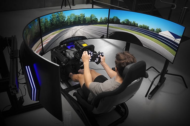 YouTube video of optimum - Tech influencer - It shows an immersive experience of playing a car racing game set up with three LG UltraGear OLED 45-inch gaming monitors.	