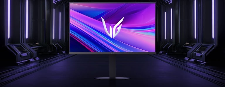 Front view of the LG UltraGear™ 27g440a gaming monitor on its hexagonal base, set in a futuristic, neon-lit corridor; the screen shows vivid purple and red swirls with the UltraGear logo at center.