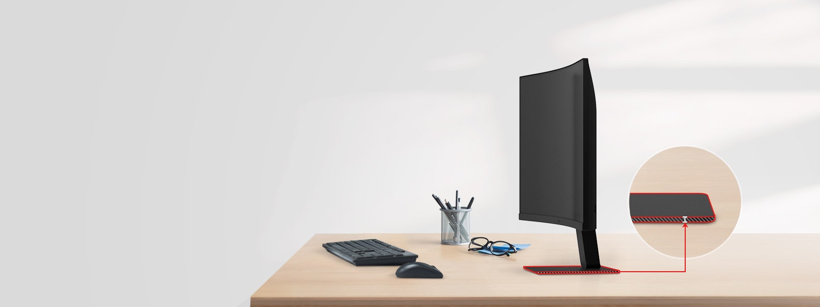 A FHD monitor with a super slim stand is on the desk, with a pencil holder, glasses, a keyboard, and a mouse next to it.	