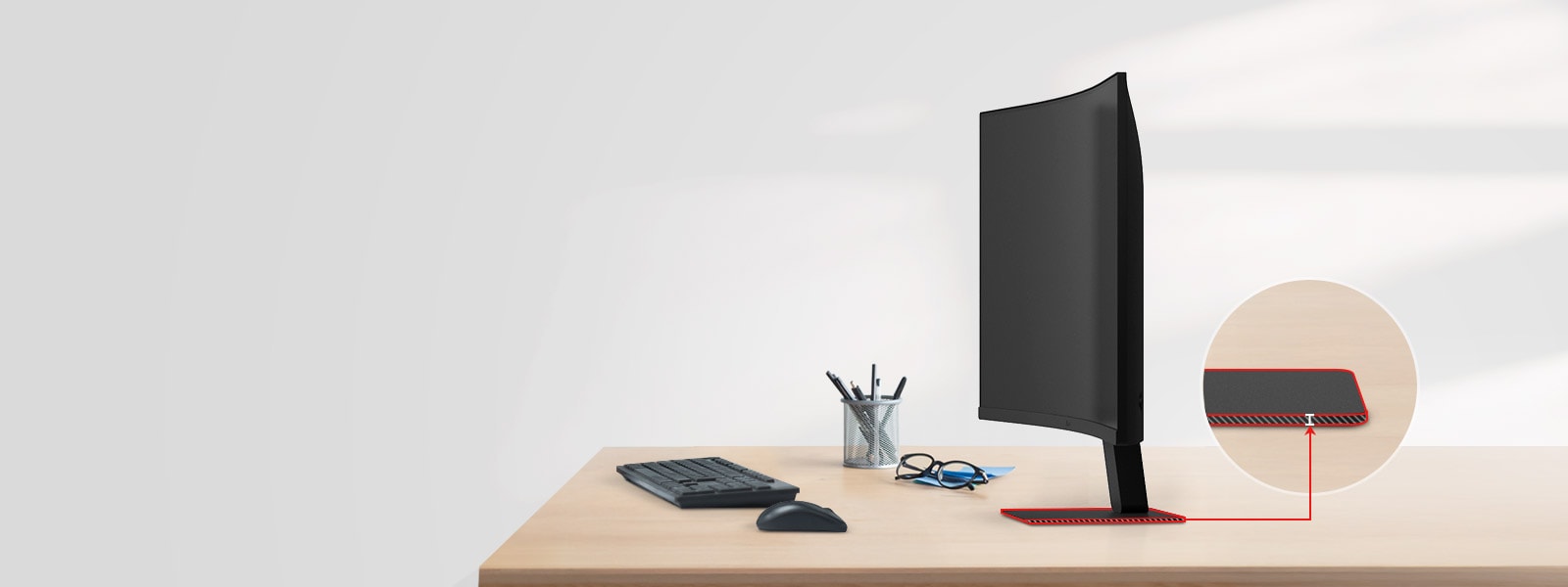 A FHD monitor with a super slim stand is on the desk, with a pencil holder, glasses, a keyboard, and a mouse next to it.	