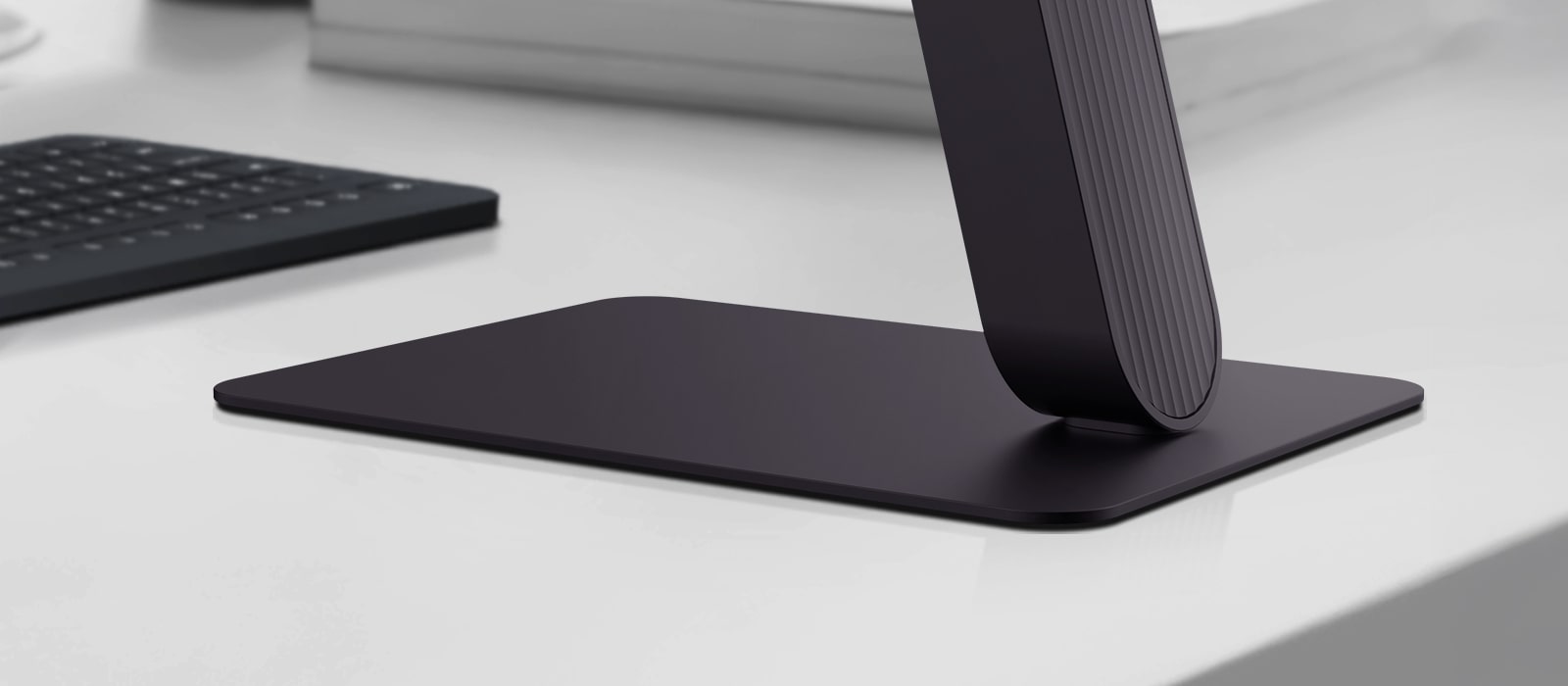 Close-up view of LG UltraGear monitor stand on a modern desk.