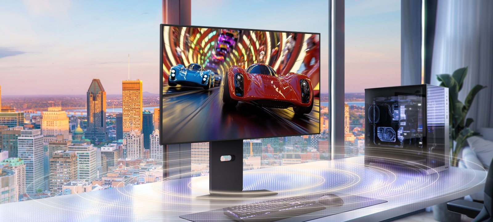 A sleek gaming monitor on a modern desk displays a high-speed racing game with two sports cars, one red and one blue, speeding through a vibrant tunnel. The setup is placed in front of large windows overlooking a city skyline at sunset, with a gaming PC on the right and soundwave graphics illustrating immersive audio effects.	