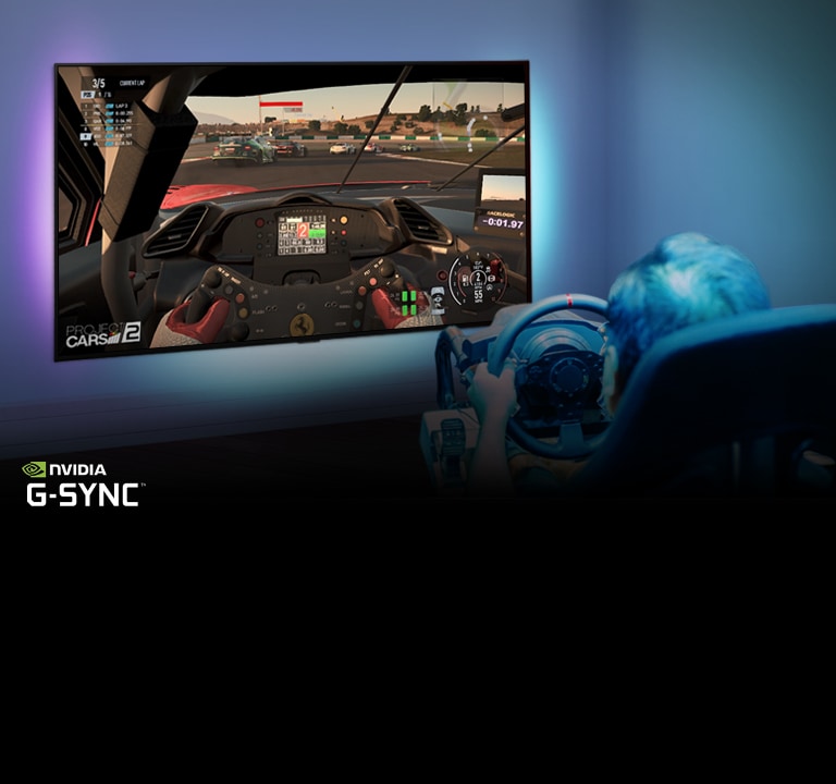 Man sitting on a racer gaming chair, holding a racing wheel while playing a racing game on a TV screen