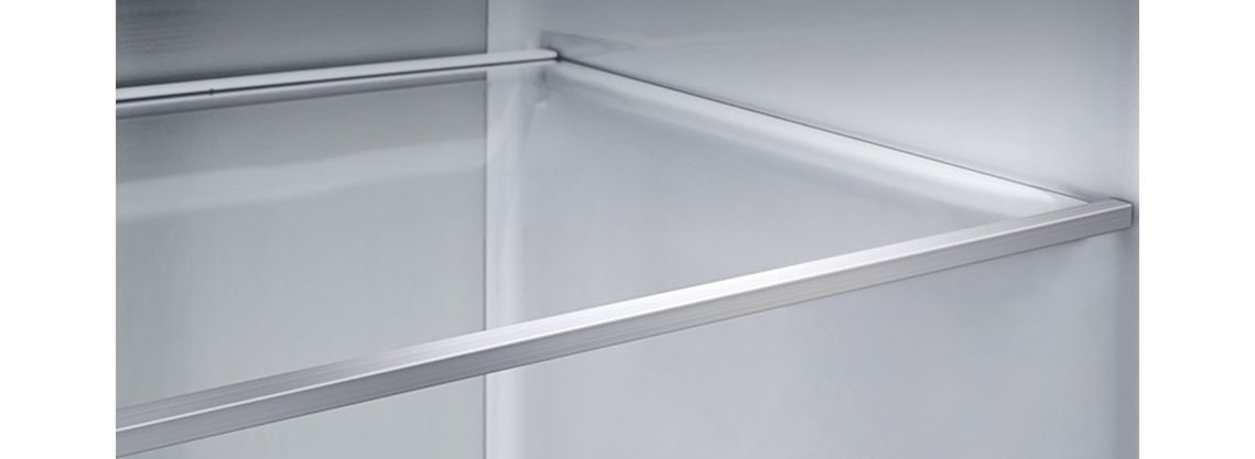 A diagonal view of the shelf with metallic paneling on the interior of the refrigerator.
