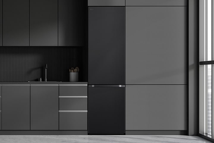 Modern kitchen with a refrigerator that blends seamlessly into surrounding cabinetry, resembling a built-in model.