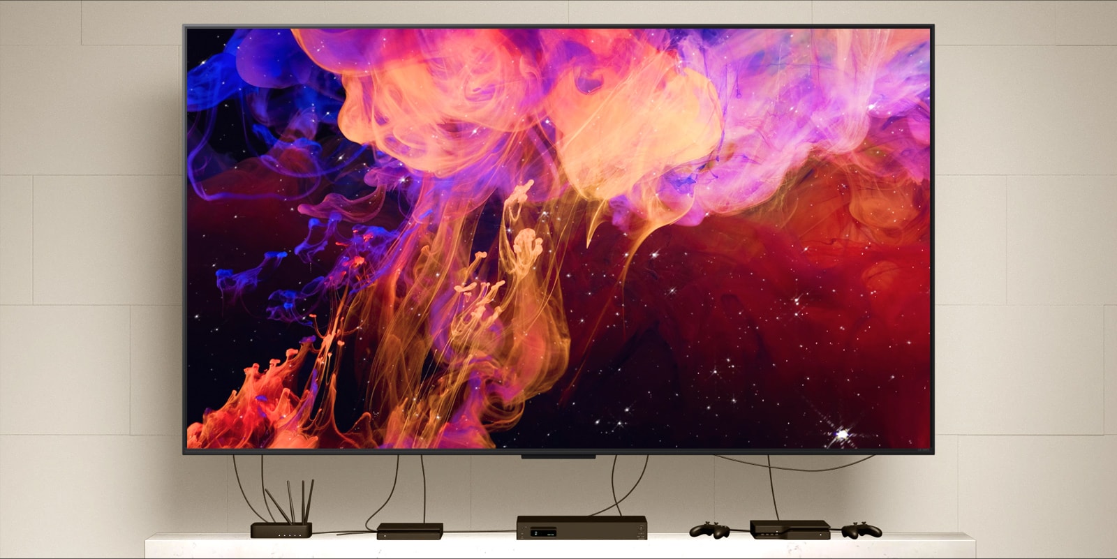 Close up of a QNED9M mounted on a wall connected to multiple devices. Wires and devices fade leaving just the QNED9M mounted on a wall. Zooms out to show the QNED9M mounted in a modern home. Zero Connect Box sits on a coffee table. 