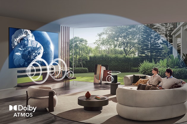 LG OLED evo AI C6 with Dolby Atmos displays a wide space scene in a living room, with graphic sound waves surrounding viewers and speakers to indicate immersive, multi-directional, object-based audio.