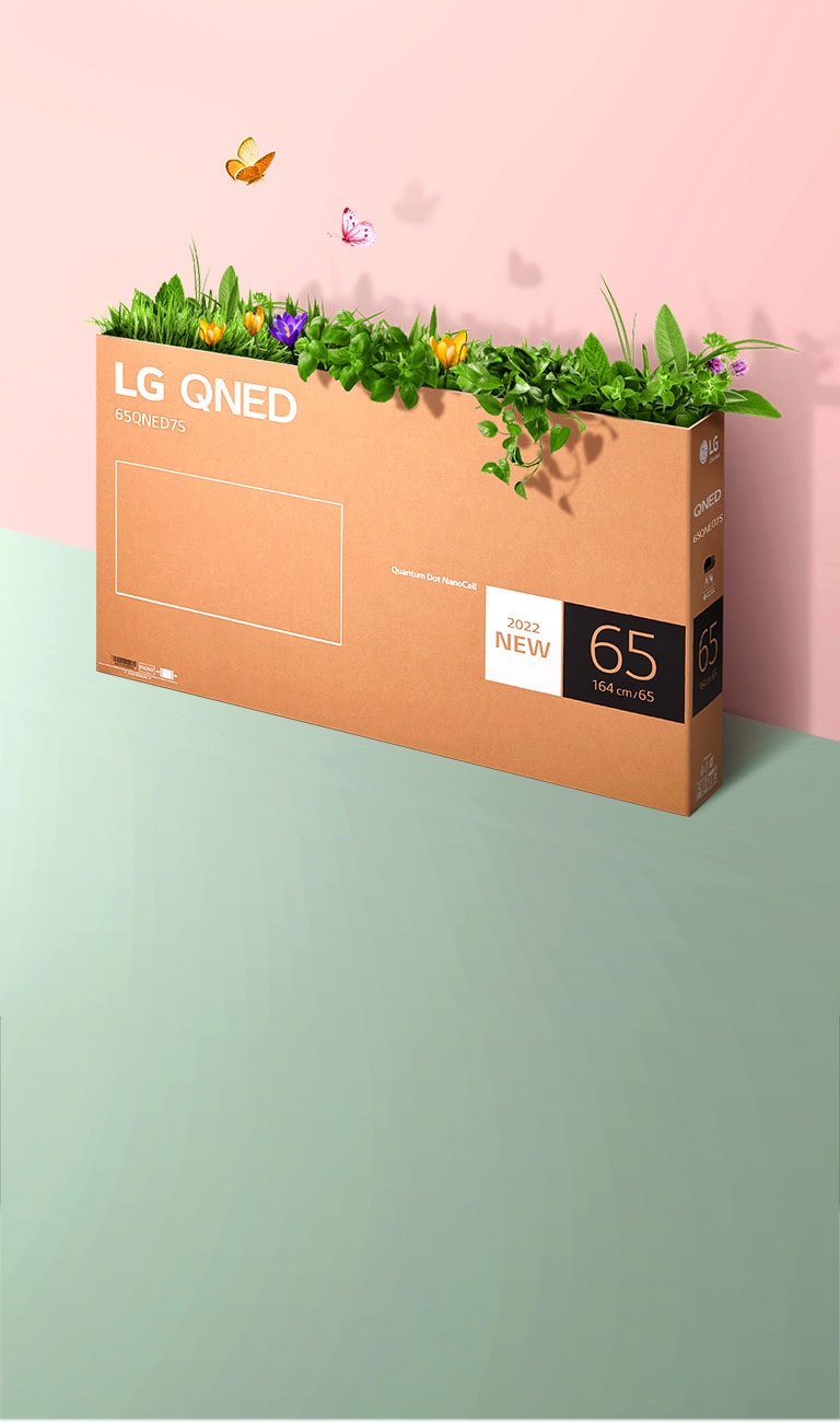 A QNED packaging box is placed on pink, green background and there is grass growing and butterflies coming out from its inside. 