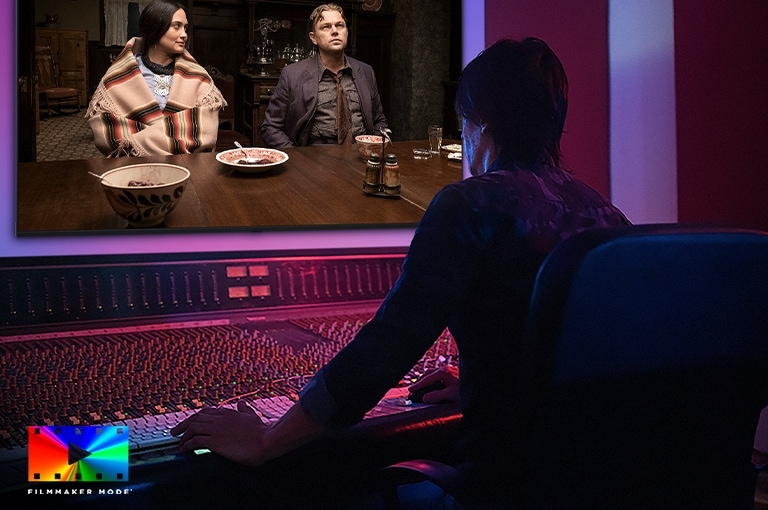 LG QNED AI QNED70 Mini LED is shown in a studio as a director works at a control panel while editing a movie displayed on screen. The FILMMAKER MODE logos appear at the bottom left.