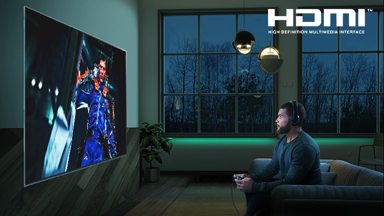 Man sitting on a sofa, holding a joystick while playing a RPG game on a TV screen