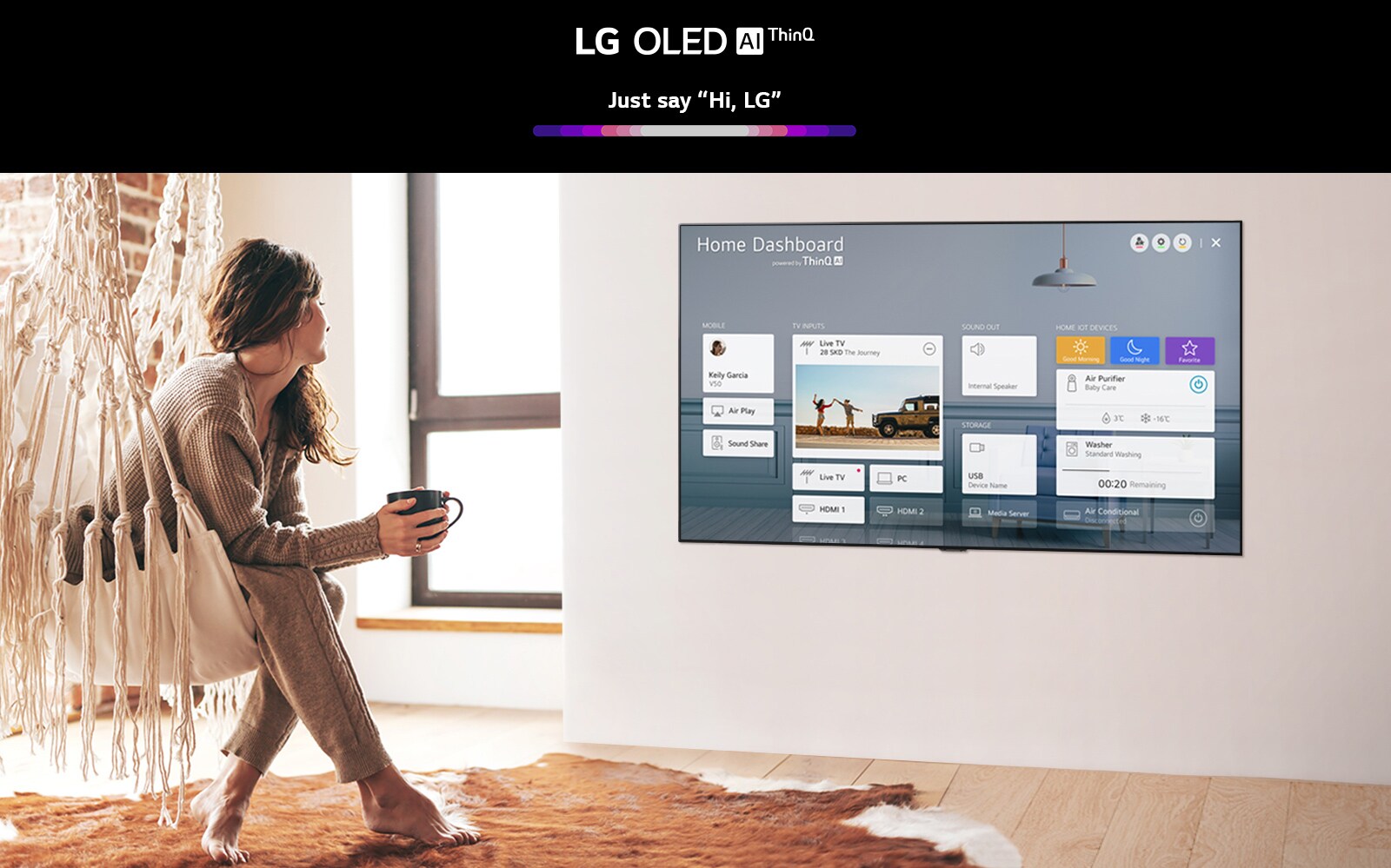 Woman sitting on a chair in the living room with the Home Dashboard on the TV screen