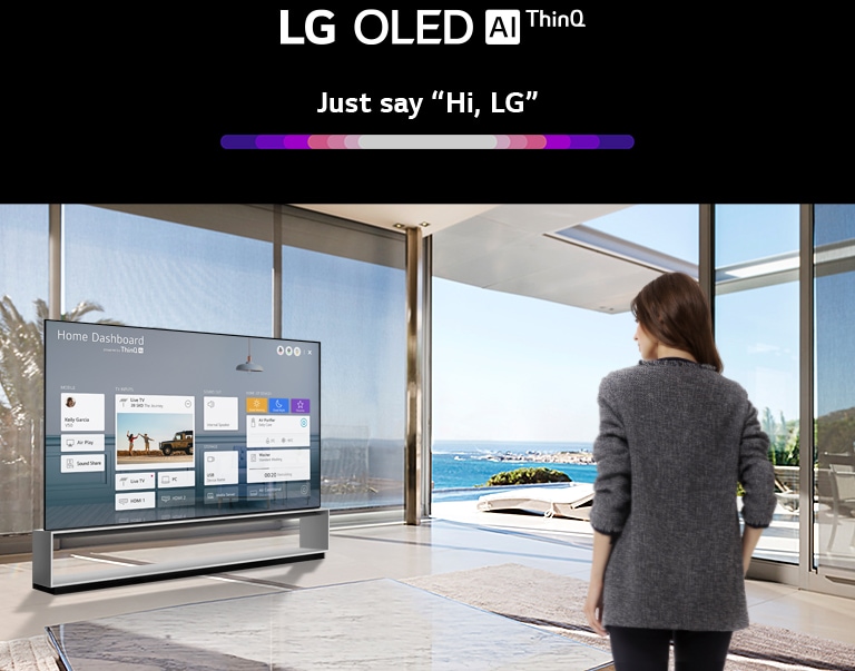 Mother and daughter sitting on a sofa in the living room with the Home Dashboard on the TV screen