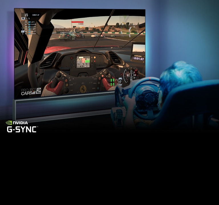 Man sitting on a racer gaming chair, holding a racing wheel while playing a racing game on a TV screen