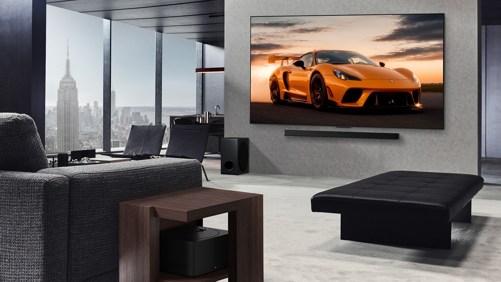 Spacious living room with a view of a cityscape. LG OLED TV is mounted on the wall with an LG Soundbar. The TV's Ultra Slim Design is showcased. Zero Connect Box is visible, but concealed.