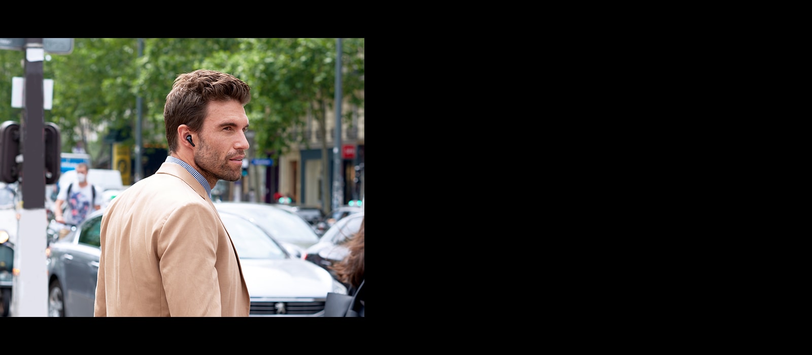 A Man is trying to cross the road while wearing TONE Free.