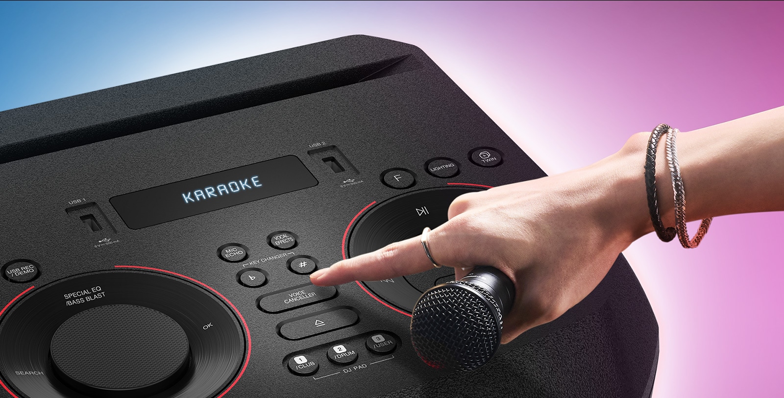 A hand holding a microphone tries to press the Voice canceller button on the top of LG XBOOM.