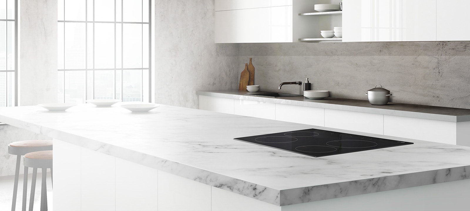 The STUDIO cooktop is installed in a kitchen island in a modern white kitchen.