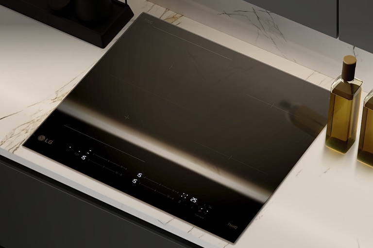 This image shows the glossy black glass finish of the induction hob.