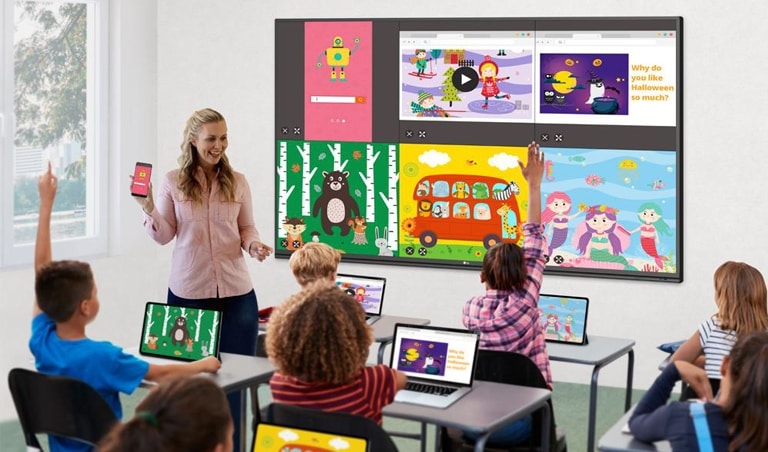 The screens of students' laptops and teacher's mobile are being shared to the display.