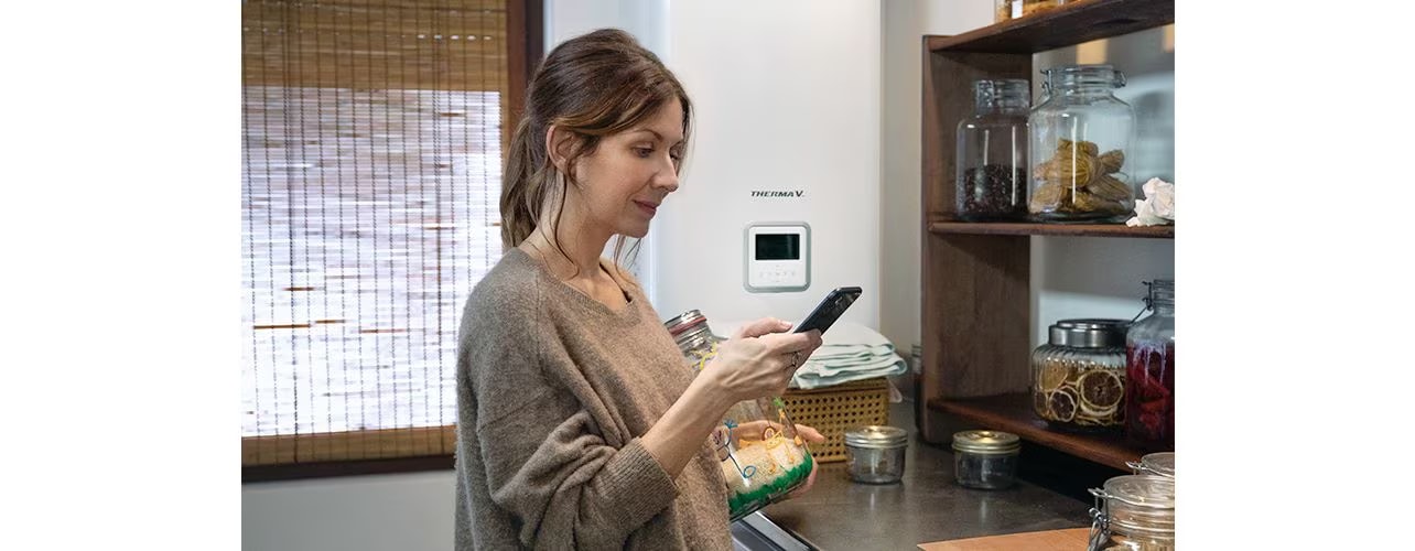 The woman is looking at her cell phone.