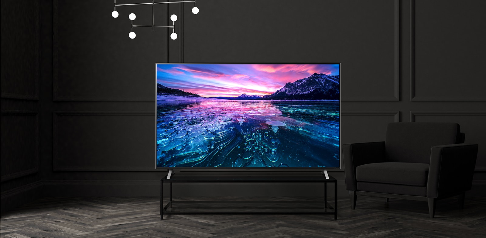 A TV on the hotel table shows a vivid and bright screen.