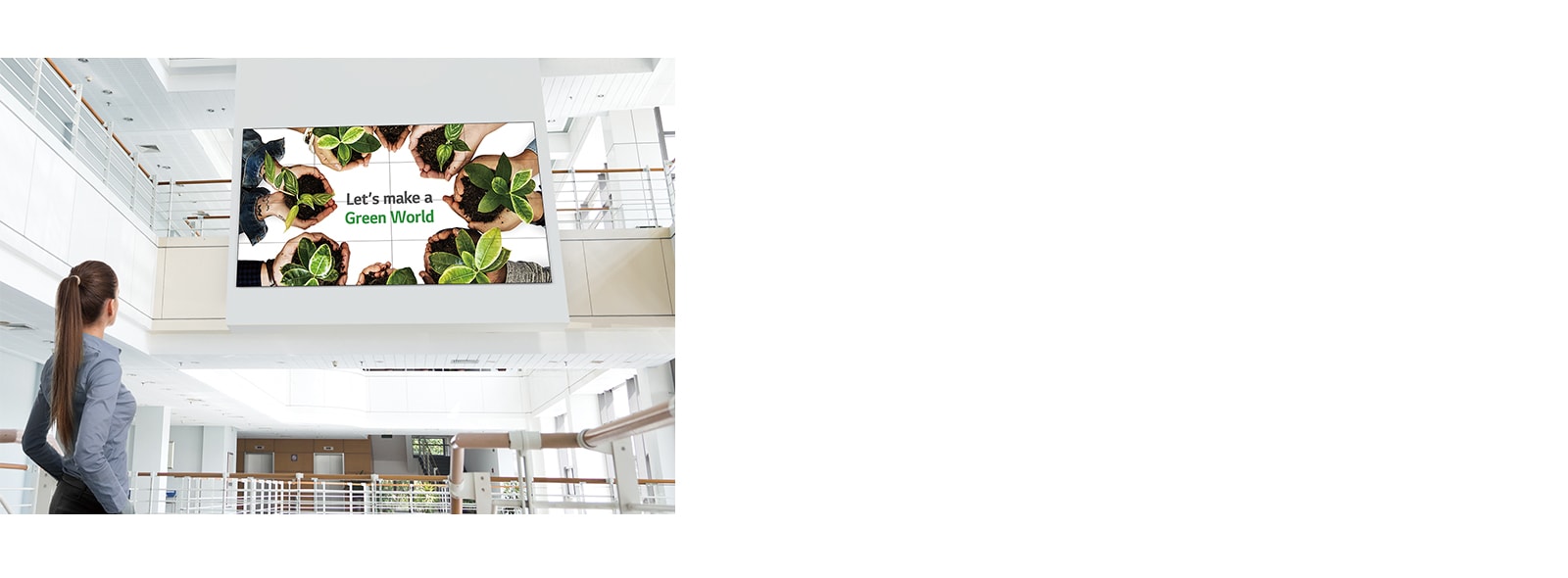 A woman is looking up at the screen installed upstairs.