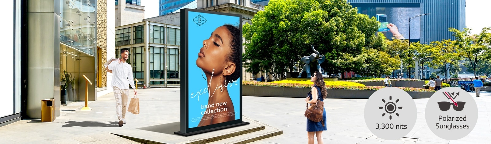 A large double-sided display is installed on the street, and a woman and man are looking at a vivid-quality advertisement on either side of the screen.