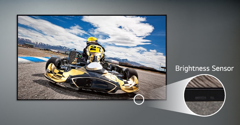 A UL5Q-E is mounted on the wall, with a close-up of the brightness sensor located on the lower front of the display.