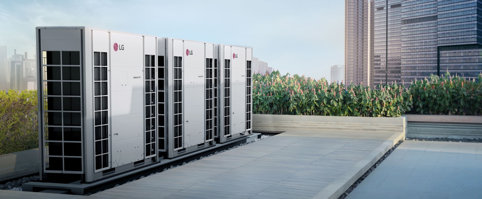 Three MULTI V i are installed on the roof of the building, and there are grasses around them.
