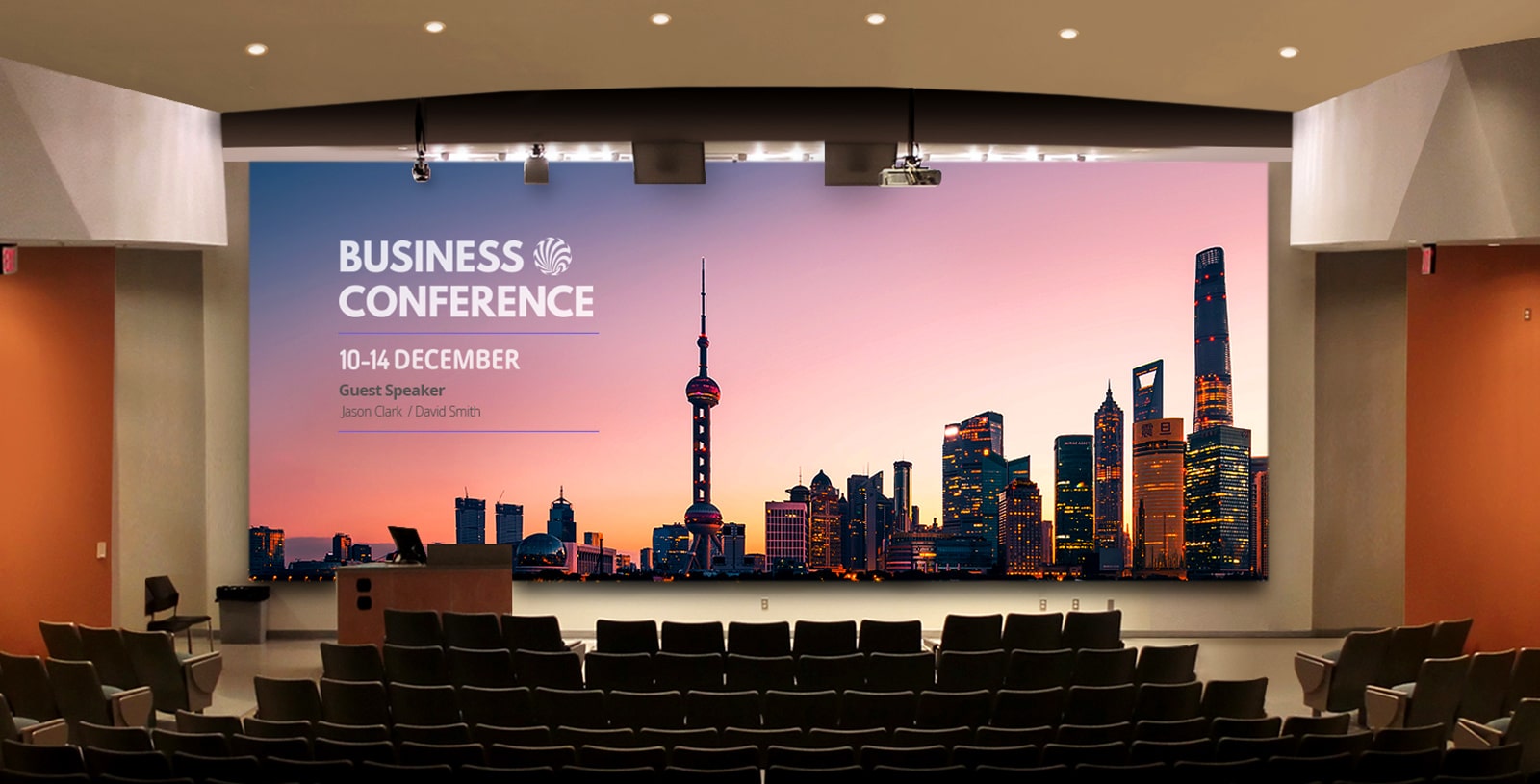 A large LED screen is installed in the auditorium, displaying the conference's agenda.