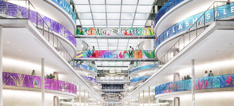 Transparent LED films are installed on the railings of several floors in the building. Even where the railing curves, the content of the transparent LED films is shown smoothly.
