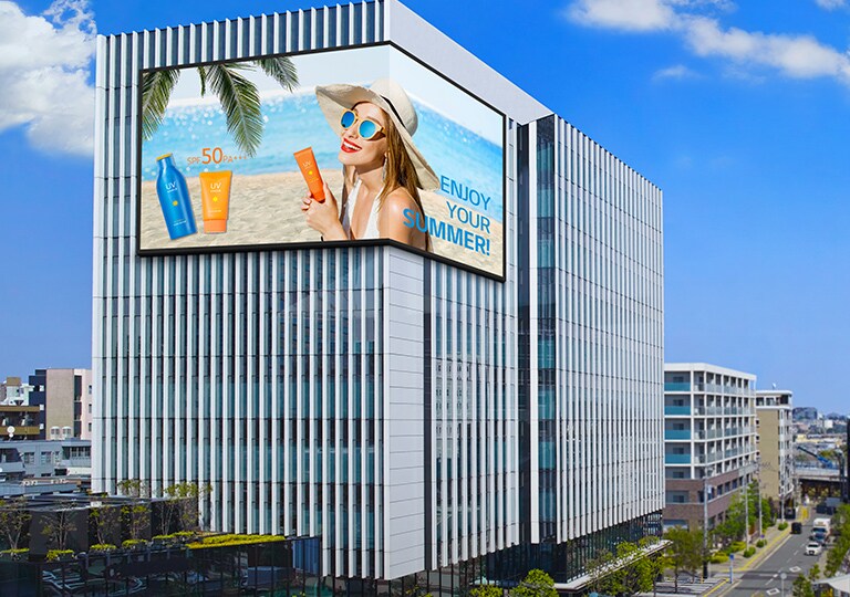 There is a screen installed on the corner of the building.