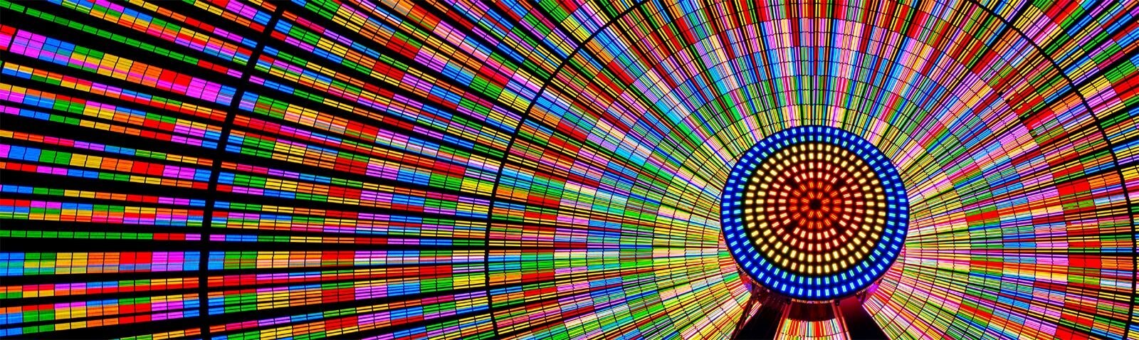 The Ferris wheel shines brightly with vibrant colors.