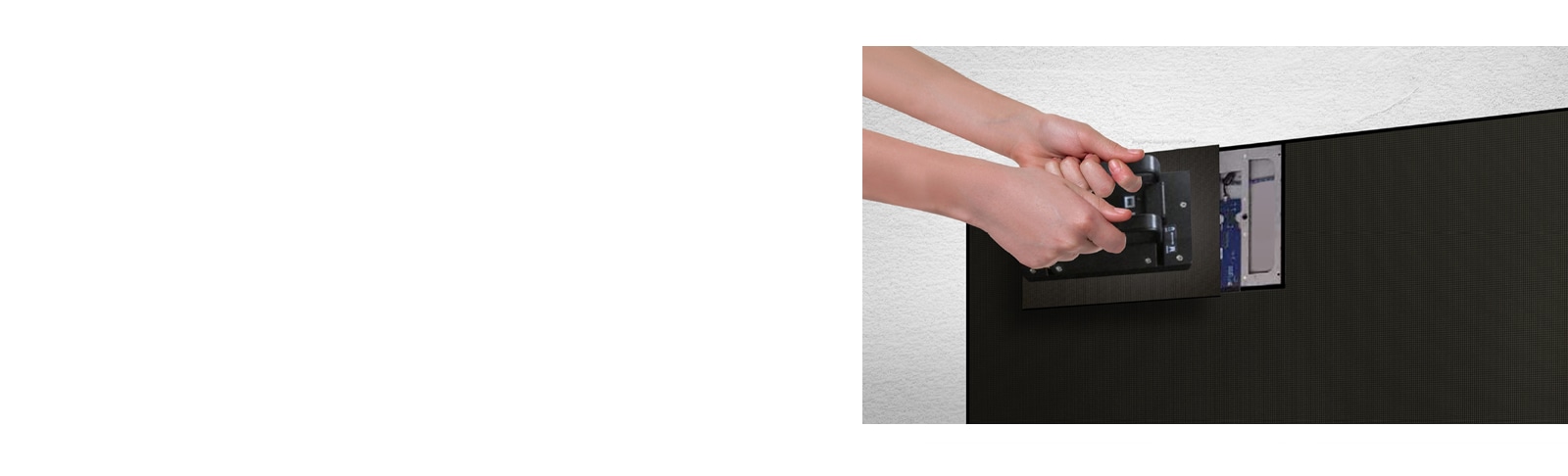 A person replaces one of the LED modules from the front by using the magnetic tool provided.